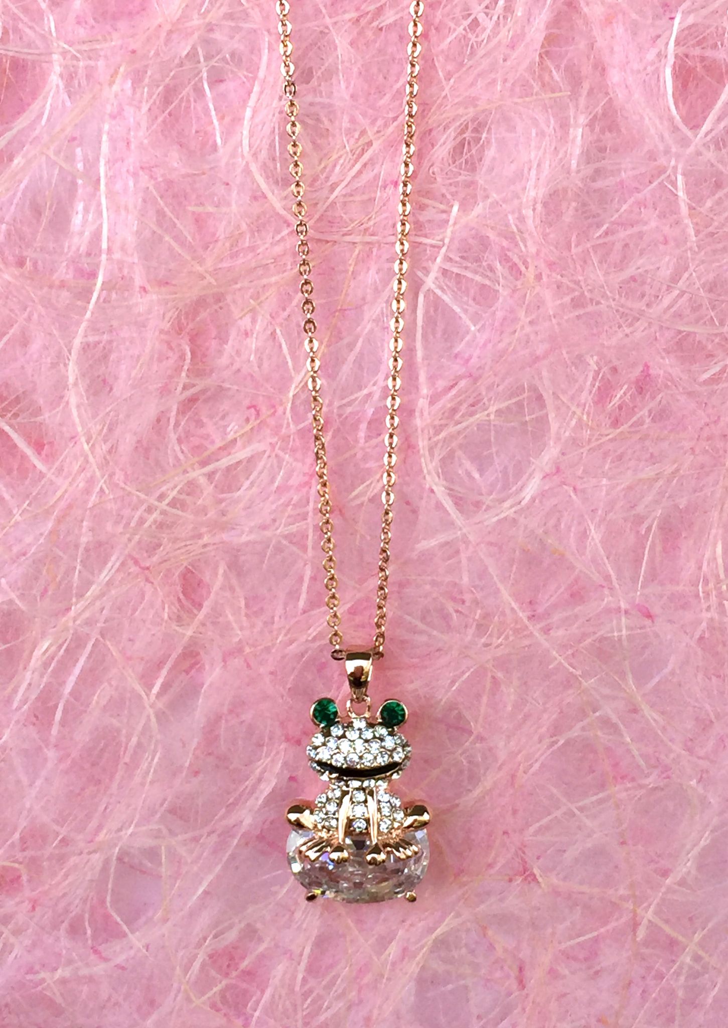 A beautiful butterfly pendant made of mother of pearl and emblazoned with small glittering crystals on a gold metal base. J020010